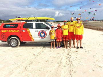 North Haven Surf Life Saving Club rescue vehicle and lifesavers in red and yellow on the beach