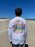 Person on the beach wearing the white long sleeve tee, back view showing the full-colour emblem