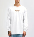 Model wearing the white Semaphore Surf Co. emblem long sleeve tee, front view with the wordmark on the chest