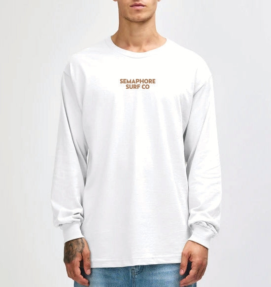 Model wearing the white Semaphore Surf Co. emblem long sleeve tee, front view with the wordmark on the chest