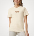 Model wearing the natural Semaphore Surf Co. emblem tee, front view with the wordmark on the chest